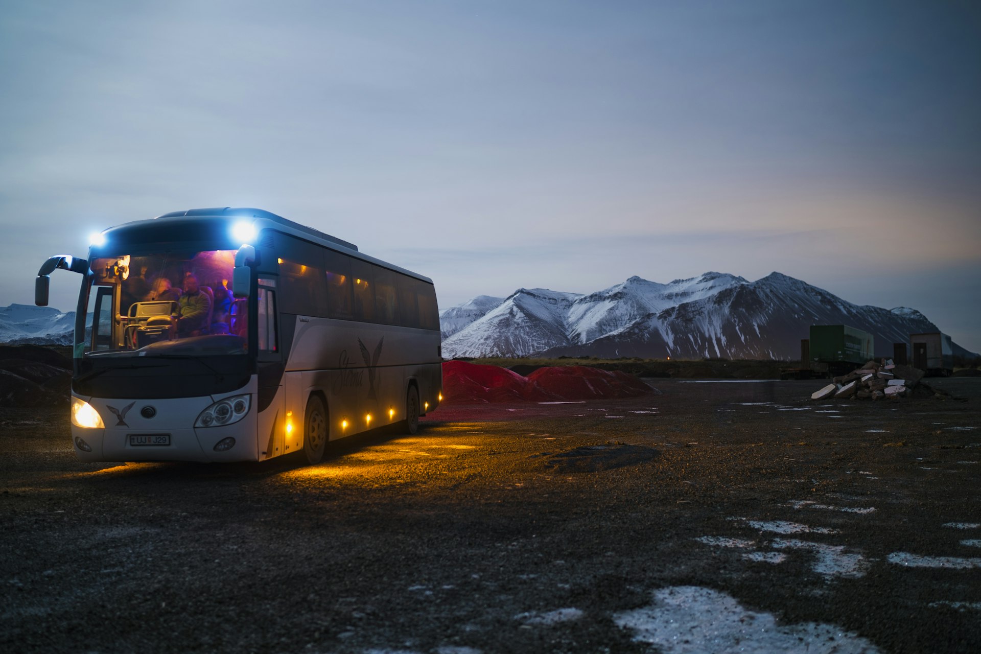 Motorcoach staged on a road under an open sky