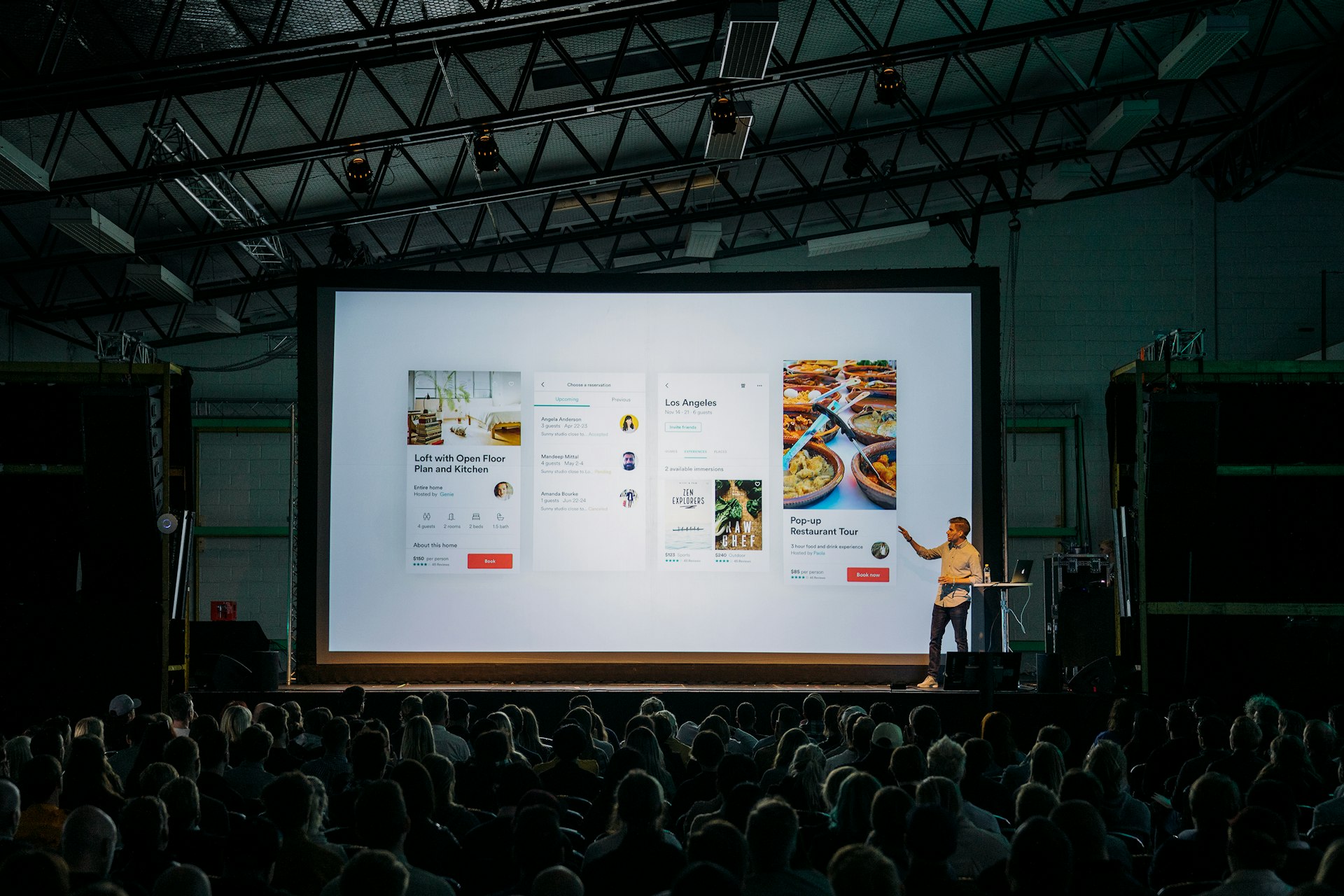 Audience seated in a darkened auditorium during a keynote